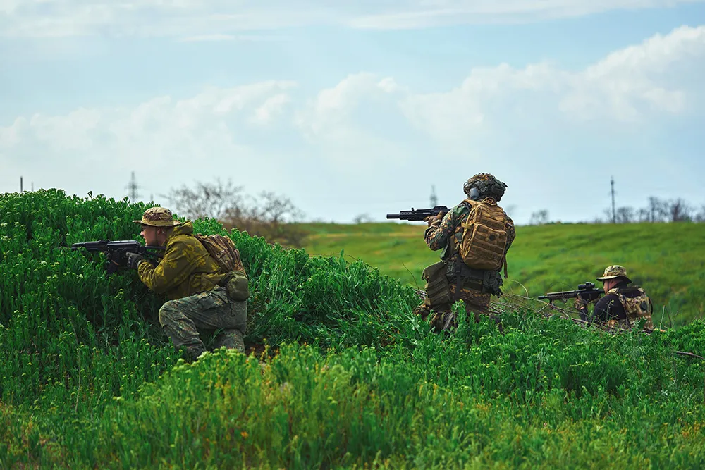 Airsoft Players Hiding Behind A Hill Are Fighting