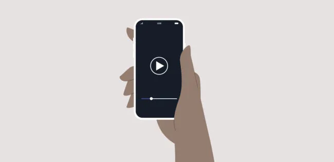 person holding a phone with a video player